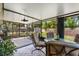 Relaxing covered patio with tile flooring, ceiling fan, and views of the backyard at 3790 Ne 22Nd Ave, Ocala, FL 34479