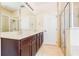 Bathroom with double sinks, dark wood cabinets, a large mirror and a separate shower stall at 3812 Creswick Cir, Orlando, FL 32829