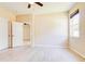 Bright bedroom featuring wood-look flooring, a ceiling fan, two closets and a window at 3812 Creswick Cir, Orlando, FL 32829