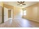 Bedroom featuring wood-look flooring, ceiling fan, and a sliding glass door leading to the patio at 3812 Creswick Cir, Orlando, FL 32829