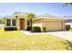 Charming single-story home featuring a well-kept lawn, mature landscaping, and an attached two-car garage at 3812 Creswick Cir, Orlando, FL 32829