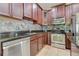 Kitchen featuring granite countertops, stainless steel appliances, tile backsplash and abundant wood cabinetry at 3812 Creswick Cir, Orlando, FL 32829