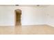 An open and bright living room featuring neutral walls and tile flooring, with an archway leading to another room at 3812 Creswick Cir, Orlando, FL 32829