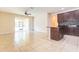 Open-concept living area with tiled floors, sliding glass doors, and kitchen view at 3812 Creswick Cir, Orlando, FL 32829