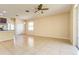 Open concept living room with tile flooring, ceiling fan and sliding doors to the outdoor patio at 3812 Creswick Cir, Orlando, FL 32829