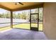 View of screened-in patio with ceiling fan overlooking a grassy backyard enclosed by a white fence at 3812 Creswick Cir, Orlando, FL 32829