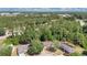 Aerial shot showcasing a home surrounded by verdant trees in a suburban setting with nearby amenities at 4 Starling Dr, Daytona Beach, FL 32117