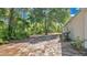 View of a spacious backyard with natural landscaping and a wooded backdrop, offering privacy at 4 Starling Dr, Daytona Beach, FL 32117