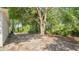 Expansive backyard with a large tree offering shade, perfect for outdoor activities at 4 Starling Dr, Daytona Beach, FL 32117