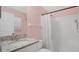 Cozy bathroom featuring a tiled shower and a vanity with a granite countertop at 4 Starling Dr, Daytona Beach, FL 32117