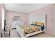 Bright bedroom with white furnishings, including a bed and dresser, enhancing the room's appeal at 4 Starling Dr, Daytona Beach, FL 32117