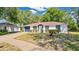 Charming single-story home with blue trim, a well-manicured lawn, and an attached garage at 4 Starling Dr, Daytona Beach, FL 32117