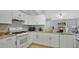 Bright kitchen with white appliances, granite countertops, and seamless connection to the living area creating an open floor plan at 4 Starling Dr, Daytona Beach, FL 32117