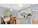 Efficient kitchen with white cabinets, stainless steel appliances, and a dining area with wood table and chairs at 4 Starling Dr, Daytona Beach, FL 32117