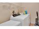 Functional laundry room equipped with a washer, dryer, and storage shelves at 4 Starling Dr, Daytona Beach, FL 32117