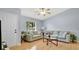 Inviting living room with light hardwood floors, comfortable sofas, and plenty of natural light from the window at 4 Starling Dr, Daytona Beach, FL 32117