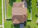 A close aerial view shows the roof in detail with the adjacent patio and manicured lawn at 4113 Longbow Dr, Clermont, FL 34711