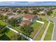 Aerial view shows the rear of a home, fenced backyard, and patio, highlighting the outdoor living space at 4113 Longbow Dr, Clermont, FL 34711