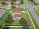Aerial shot of a home with a large backyard, complete with a white picket fence and mature trees at 4113 Longbow Dr, Clermont, FL 34711