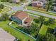 Aerial shot featuring a house with a fenced yard and a paved patio area for outdoor enjoyment at 4113 Longbow Dr, Clermont, FL 34711