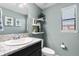 Stylish powder room featuring granite counters, a modern vanity, decorative shelves, and a bright window at 4113 Longbow Dr, Clermont, FL 34711