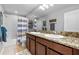 Bathroom with dual sinks, granite countertops, and a shower/tub combination at 4113 Longbow Dr, Clermont, FL 34711