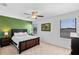 Spacious bedroom with a accent wall, and bright light from windows at 4113 Longbow Dr, Clermont, FL 34711