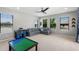 Inviting bonus room features large windows, neutral paint, and plush furniture for recreation and relaxation at 4113 Longbow Dr, Clermont, FL 34711