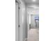 Bright hallway with carpet floors, neutral paint, and a window that lets in natural light at 4113 Longbow Dr, Clermont, FL 34711