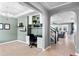 Open office space with coffered ceiling, built-in shelving, and easy access to the staircase at 4113 Longbow Dr, Clermont, FL 34711