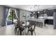 Eat-in kitchen features an island with seating, stainless appliances, and easy access to the patio at 4113 Longbow Dr, Clermont, FL 34711