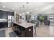 Kitchen with center island and barstool seating open to dining and living spaces at 4113 Longbow Dr, Clermont, FL 34711