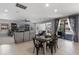 Living room with dining area featuring tile floors, neutral decor, and sliding glass doors at 4113 Longbow Dr, Clermont, FL 34711