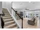Bright living room featuring a staircase, open floor plan, and comfortable seating at 4113 Longbow Dr, Clermont, FL 34711