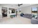 Living room featuring modern furniture, neutral decor, and an open layout to the dining area at 4113 Longbow Dr, Clermont, FL 34711