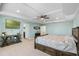 The main bedroom offers a tray ceiling, a comfortable king-sized bed, and stylish decor at 4113 Longbow Dr, Clermont, FL 34711