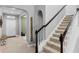 Elegant staircase with carpeted steps and a white railing adjacent to the foyer at 4113 Longbow Dr, Clermont, FL 34711