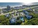 An aerial view showcasing the coastal community with its pool, landscaping, proximity to the beach, and surrounding buildings at 4244 Sun Village Ct # 160, New Smyrna Beach, FL 32169