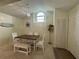 Well-lit dining area with a wood table, charming chandelier, and coastal-themed decor for a welcoming ambiance at 4244 Sun Village Ct # 160, New Smyrna Beach, FL 32169