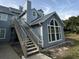 Exterior of blue multi-story townhome with staircase at 4244 Sun Village Ct # 160, New Smyrna Beach, FL 32169