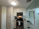 Modern kitchen featuring granite counters, stainless appliances, and white shaker cabinets at 4244 Sun Village Ct # 160, New Smyrna Beach, FL 32169