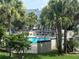 Community pool surrounded by lush landscaping and lounge chairs at 4244 Sun Village Ct # 160, New Smyrna Beach, FL 32169
