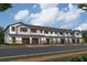 Charming townhomes feature attached garages, neutral colors, brick accents, and inviting entryways at 4291 Campsite Loop, Orlando, FL 32824