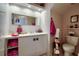 Cozy bathroom features a vanity with drawers, a toilet, a mirror, and updated lighting at 4381 Creekside Blvd, Kissimmee, FL 34746