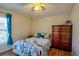Cozy bedroom featuring a ceiling fan, wood floors, and a bright window at 4381 Creekside Blvd, Kissimmee, FL 34746