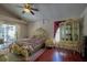 Comfortable bedroom featuring a unique bedframe, ceiling fan, and access to patio at 4381 Creekside Blvd, Kissimmee, FL 34746