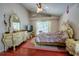 Comfortable bedroom features a ceiling fan, plush rug, and an eye-catching vanity set at 4381 Creekside Blvd, Kissimmee, FL 34746