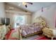 Comfortable bedroom features a ceiling fan, plush rug, and direct access to the screened-in lanai at 4381 Creekside Blvd, Kissimmee, FL 34746