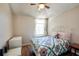 Small bedroom with wood flooring, a bed with a decorative quilt, and natural light from a window at 4381 Creekside Blvd, Kissimmee, FL 34746