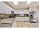 Clean kitchen featuring white cabinets, stainless steel appliances, granite countertops and a tiled backsplash at 4381 Creekside Blvd, Kissimmee, FL 34746